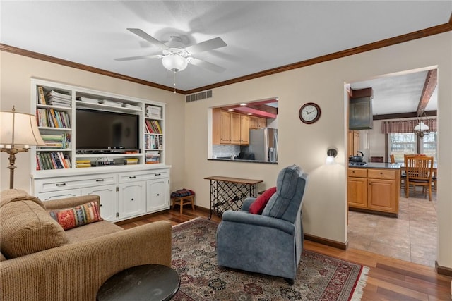 living room featuring visible vents, wood finished floors, ceiling fan, and ornamental molding