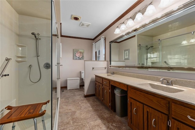 full bathroom featuring double vanity, walk in shower, ornamental molding, and a sink