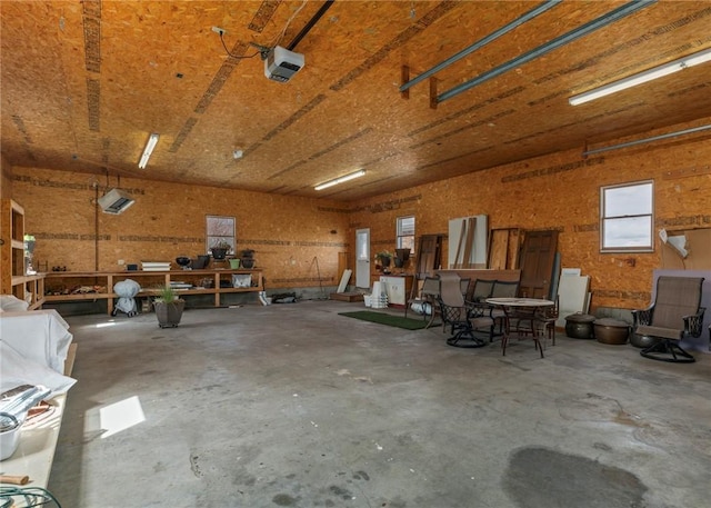 garage with a garage door opener and a workshop area