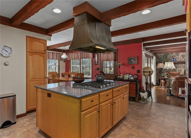 kitchen featuring island range hood, beam ceiling, a wealth of natural light, and stainless steel gas cooktop