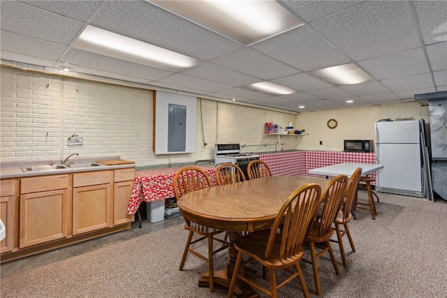 9769 Loy Chapel Rd, Effingham, IL 62401 - dining space with a paneled ceiling, electric panel, brick wall, and light colored carpet