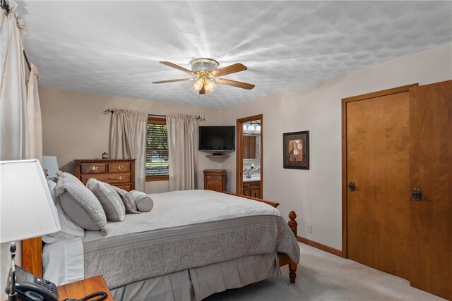 9769 Loy Chapel Rd, Effingham, IL 62401 - bedroom with light colored carpet, baseboards, ceiling fan, and connected bathroom