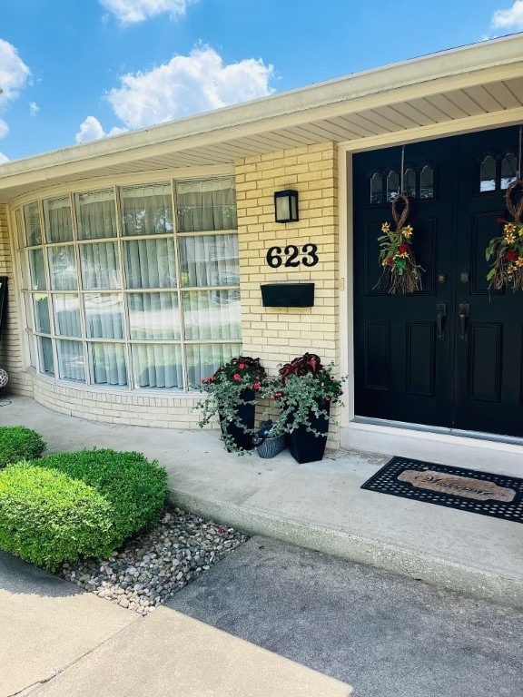 view of exterior entry featuring covered porch