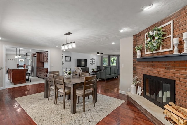 100 Pine Dr, Effingham, IL 62401 - dining room with a brick fireplace, a ceiling fan, hardwood / wood-style floors, baseboards, and recessed lighting