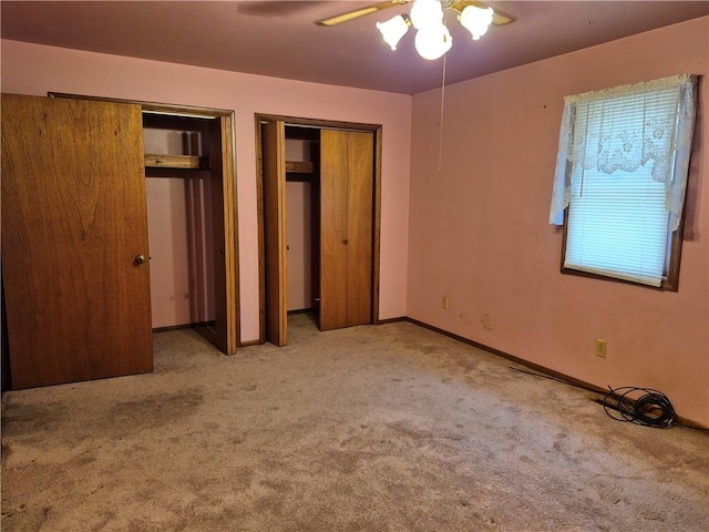 910 Glendale Ave, Tilton, IL 61833 - unfurnished bedroom with light carpet, two closets, and ceiling fan
