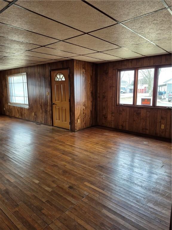 910 Glendale Ave, Tilton, IL 61833 - interior space featuring a paneled ceiling, dark hardwood / wood-style floors, and wood walls