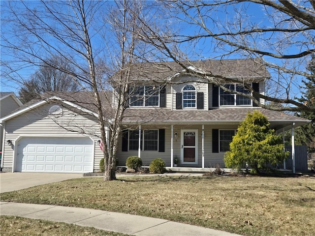 traditional-style house featuring a garage, a front yard, driveway, and a shingled roof