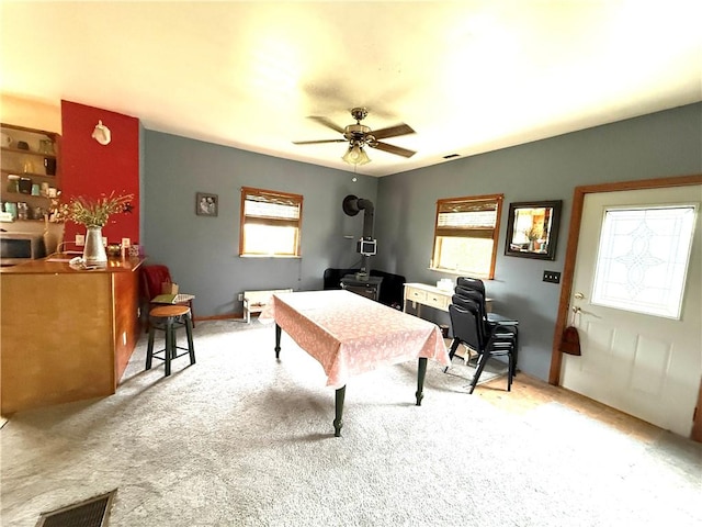 1953 E 4200 N Rd, Rankin, IL 60960 - recreation room with a ceiling fan, light carpet, and a wood stove