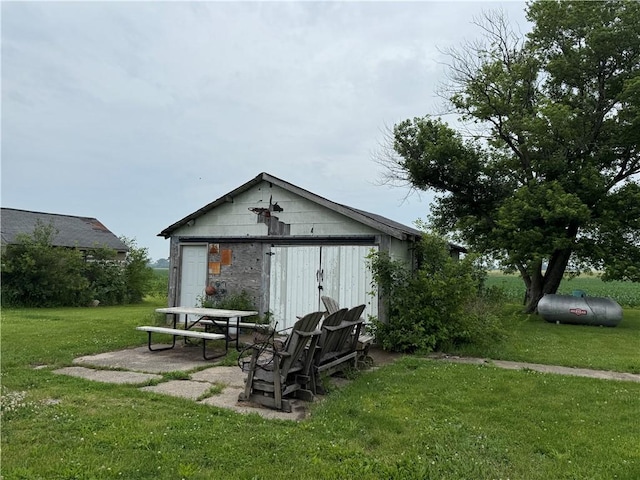 1953 E 4200 N Rd, Rankin, IL 60960 - rear view of property featuring a lawn and an outbuilding