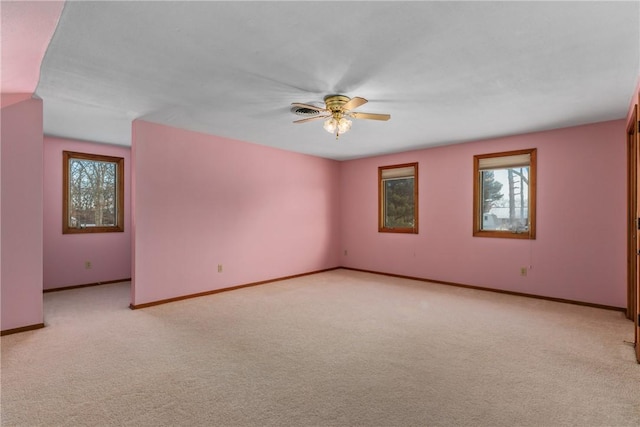 carpeted spare room featuring ceiling fan