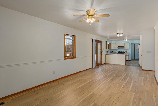 unfurnished living room featuring ceiling fan and light hardwood / wood-style flooring