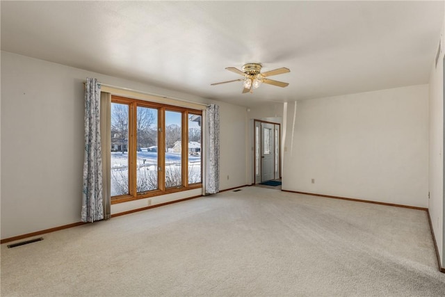 carpeted spare room featuring ceiling fan