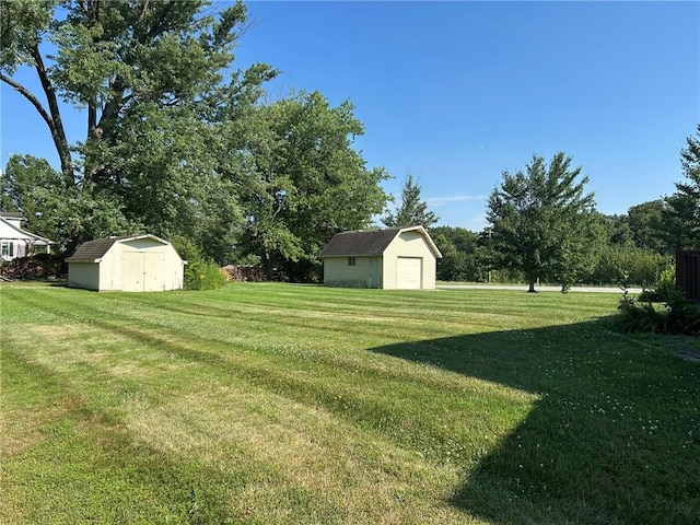 16142 Country Estates Rd, Effingham, IL 62401 - view of grassy yard with a storage shed and a garage