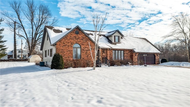 view of front of property featuring a garage and a shed