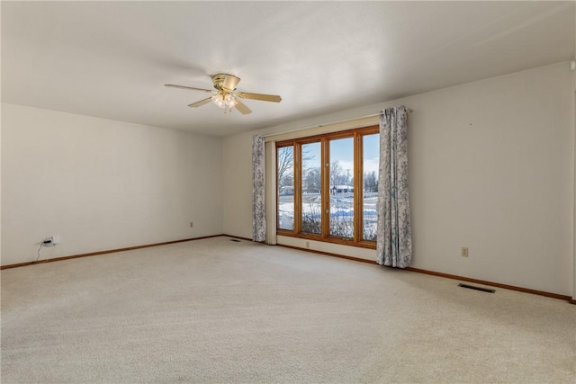 unfurnished room featuring light carpet and ceiling fan