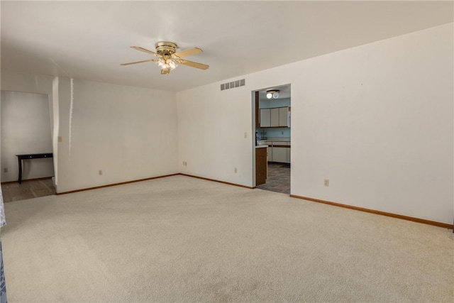 carpeted empty room with ceiling fan