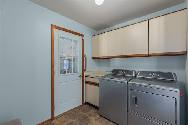 laundry room with cabinets and washing machine and clothes dryer