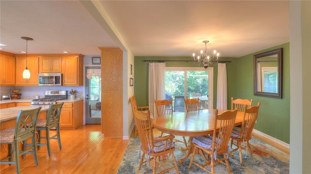 1950 Shore Oak Dr, Decatur, IL 62521 - dining area featuring light wood-type flooring and a chandelier