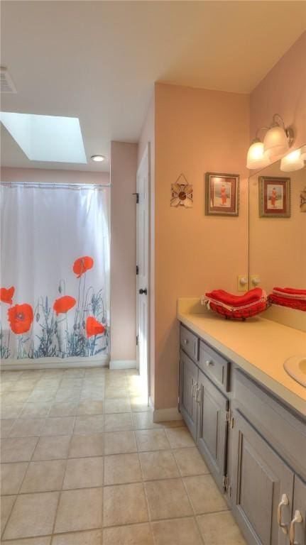 1950 Shore Oak Dr, Decatur, IL 62521 - bathroom with a skylight, vanity, a shower with curtain, and tile patterned floors