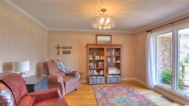 1950 Shore Oak Dr, Decatur, IL 62521 - living area with healthy amount of natural light, ornamental molding, light wood finished floors, and a chandelier