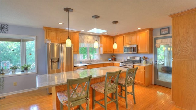 1950 Shore Oak Dr, Decatur, IL 62521 - kitchen with stainless steel appliances, light wood-style floors, plenty of natural light, a breakfast bar, and recessed lighting