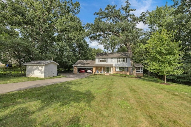 530 Powers Ln, Decatur, IL 62522 - view of front of property with driveway, a storage unit, brick siding, and an attached carport
