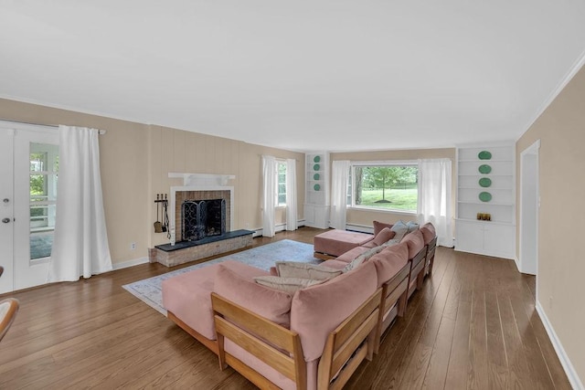530 Powers Ln, Decatur, IL 62522 - living area featuring hardwood / wood-style flooring, built in features, a fireplace, baseboard heating, and ornamental molding