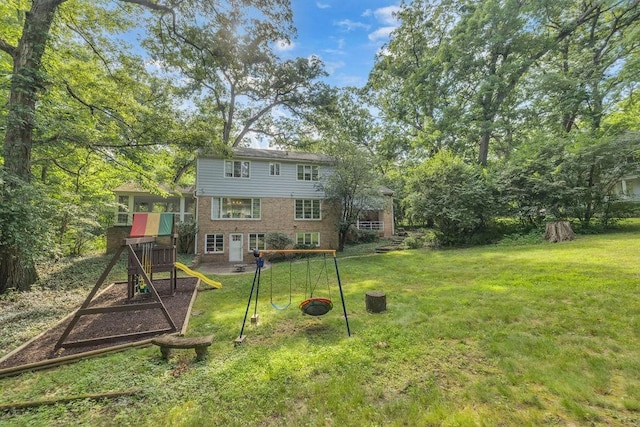 530 Powers Ln, Decatur, IL 62522 - rear view of property featuring a playground, a yard, and brick siding