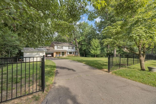 530 Powers Ln, Decatur, IL 62522 - view of front of property with asphalt driveway, a gate, and view of wooded area
