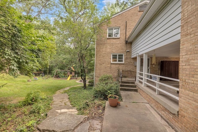530 Powers Ln, Decatur, IL 62522 - view of grassy yard with a playground and a patio