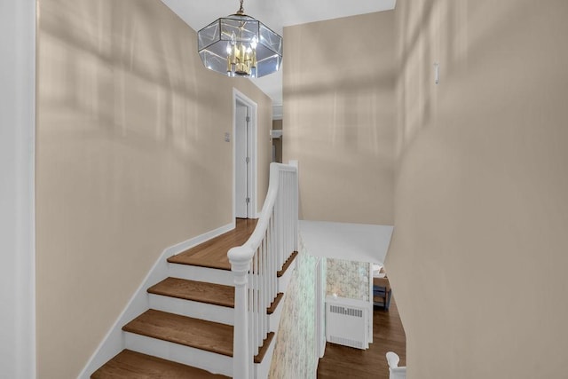 530 Powers Ln, Decatur, IL 62522 - stairs with radiator heating unit, a chandelier, and wood finished floors