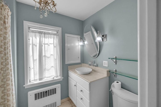 530 Powers Ln, Decatur, IL 62522 - bathroom with radiator, vanity, tile patterned floors, and a chandelier