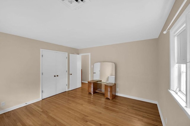 530 Powers Ln, Decatur, IL 62522 - unfurnished bedroom featuring light wood-style floors and a closet