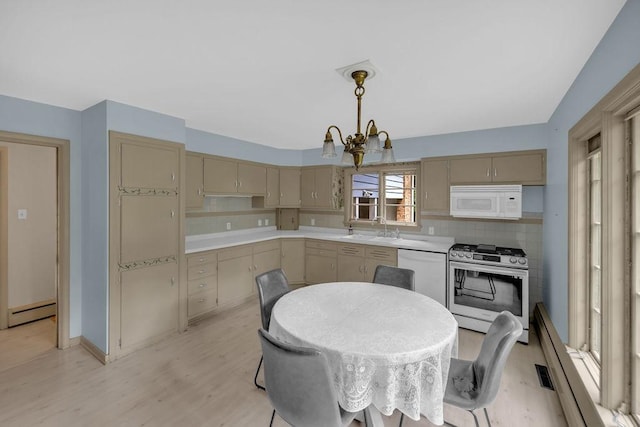 530 Powers Ln, Decatur, IL 62522 - kitchen with white appliances, tasteful backsplash, light countertops, and a chandelier