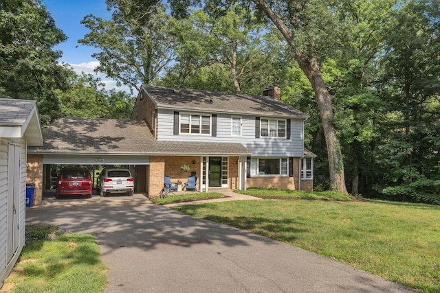 530 Powers Ln, Decatur, IL 62522 - view of front facade featuring driveway, a chimney, a front yard, and brick siding