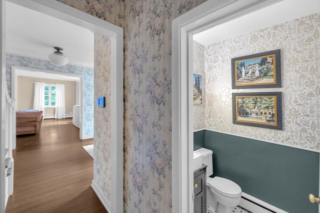 530 Powers Ln, Decatur, IL 62522 - bathroom with wallpapered walls, wood finished floors, a baseboard heating unit, and wainscoting