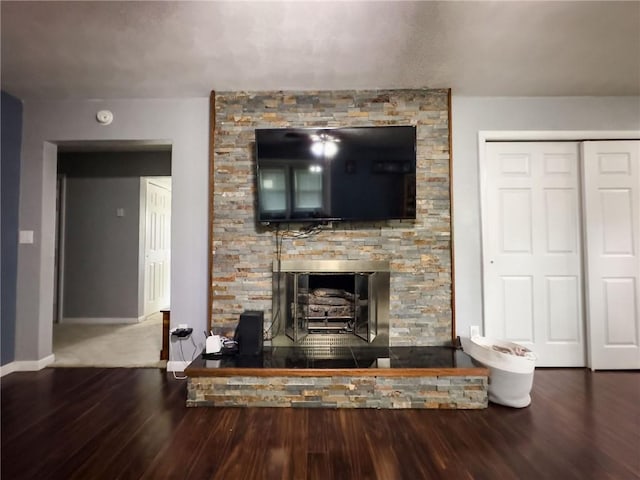 201 N York St, Martinsville, IL 62442 - living area featuring a stone fireplace, wood finished floors, and baseboards
