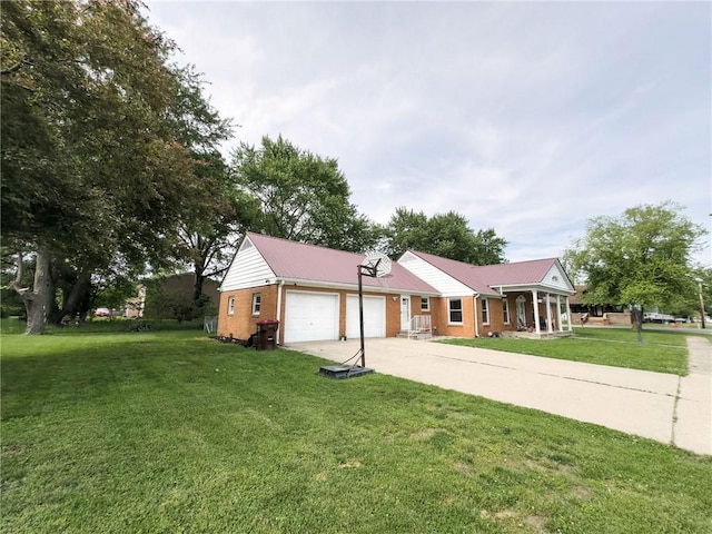201 N York St, Martinsville, IL 62442 - view of front of house with an attached garage, brick siding, driveway, a front yard, and metal roof