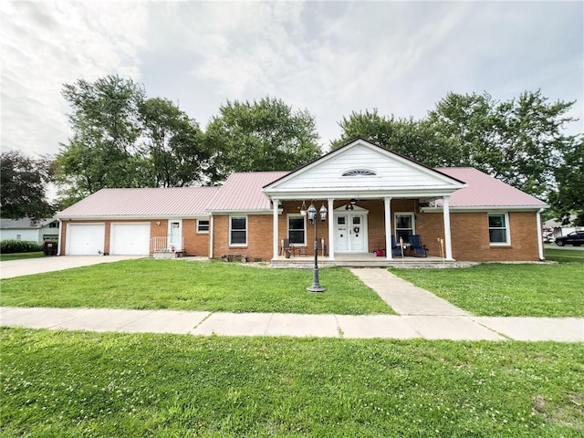 201 N York St, Martinsville, IL 62442 - view of front of house featuring a porch, a front lawn, driveway, and brick siding