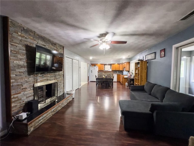 201 N York St, Martinsville, IL 62442 - living area featuring ceiling fan, dark wood-type flooring, and a fireplace