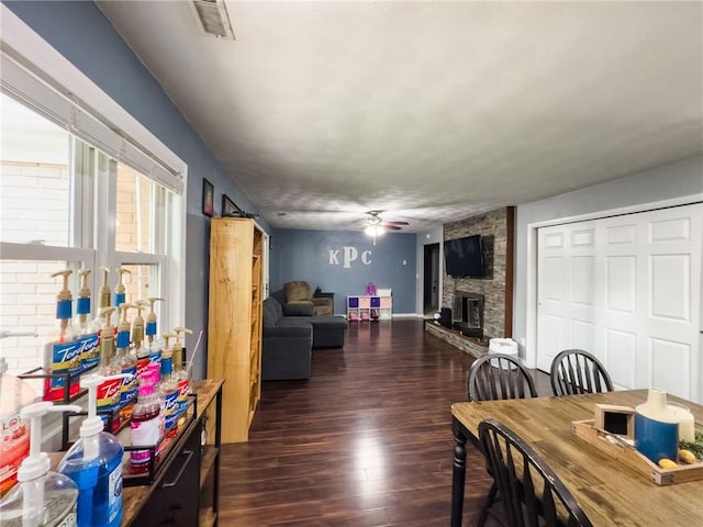 201 N York St, Martinsville, IL 62442 - dining space with dark wood finished floors, a ceiling fan, and a fireplace