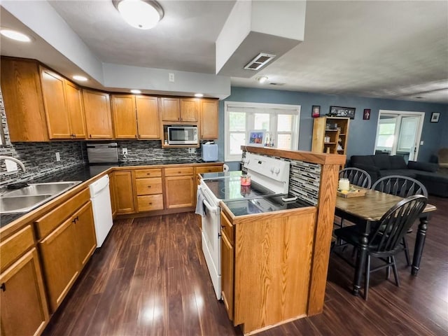 201 N York St, Martinsville, IL 62442 - kitchen with white appliances, a sink, dark wood-style flooring, a center island, and decorative backsplash