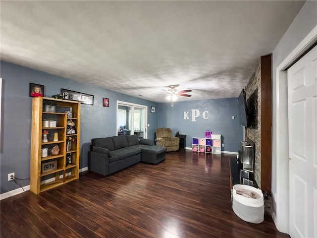 201 N York St, Martinsville, IL 62442 - living room featuring wood finished floors, ceiling fan, baseboards, and a fireplace
