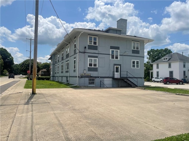 428 E Main St, Hoopeston, IL 60942 - rear view of house with a chimney and stucco siding