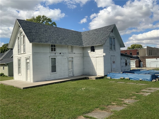 rear view of property with a lawn