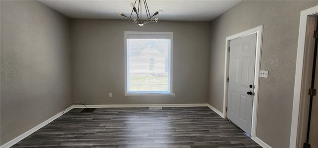1420 E Main St, Decatur, IL 62521 - unfurnished room featuring dark wood finished floors and a chandelier