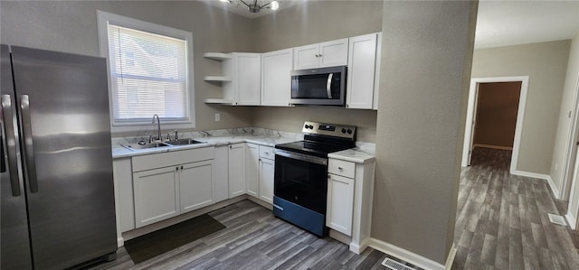 1420 E Main St, Decatur, IL 62521 - kitchen with appliances with stainless steel finishes, open shelves, wood finished floors, white cabinetry, and a textured wall