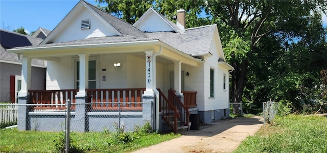 1420 E Main St, Decatur, IL 62521 - view of front of house featuring a porch, a shingled roof, a chimney, and driveway