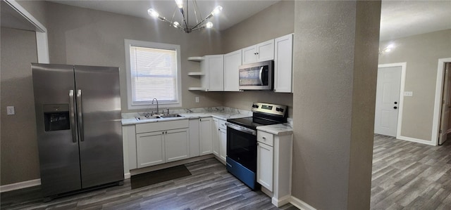 1420 E Main St, Decatur, IL 62521 - kitchen featuring stainless steel appliances, open shelves, dark wood finished floors, light countertops, and white cabinets