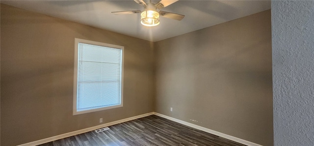1420 E Main St, Decatur, IL 62521 - empty room with dark wood-style floors and ceiling fan